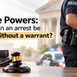 An image displaying law books and a gavel on a table with a police officer detaining a suspect in handcuffs in the background, overlaid with the text "Police Powers: When can an arrest be made without a warrant?